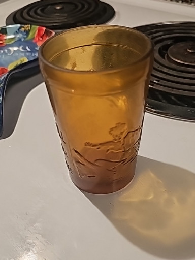 Amber pressed glass tumbler with 'Jack and Jill' nursery rhyme motif by Tiara Indiana Glass
