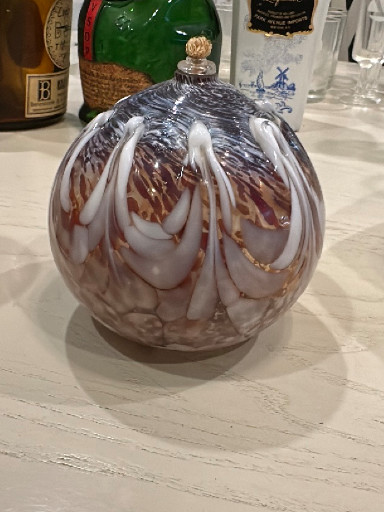 Handblown art glass oil lamp with iridescent pink and white swirl pattern