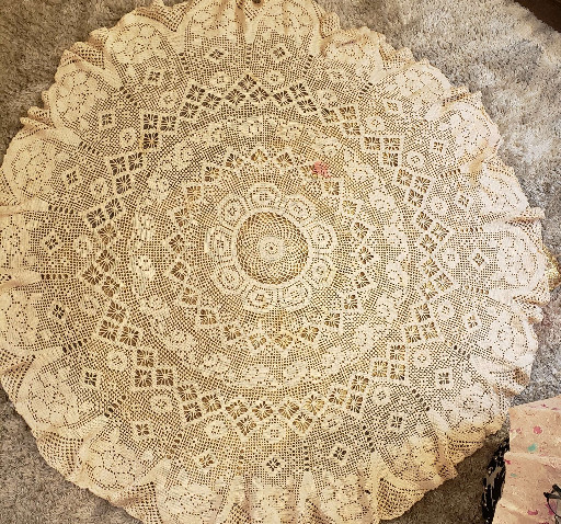 Hand-crocheted cotton lace tablecloth with intricate floral and geometric pattern