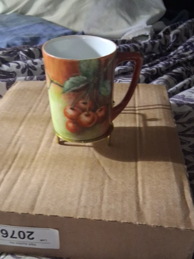 Hand-painted porcelain mug with fruit decoration
