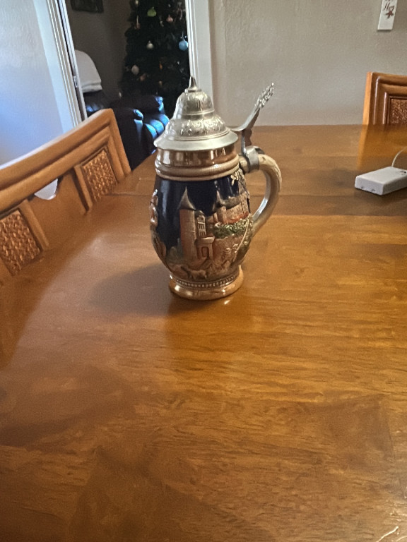 German ceramic beer stein with pewter lid featuring Alpine scenes
