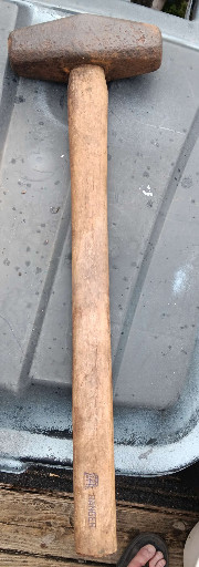 Vintage wooden-handled sledgehammer with cylindrical head