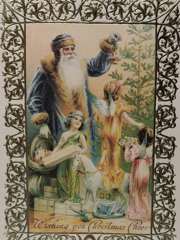Vintage German Christmas postcard featuring Father Christmas in a blue robe with children decorating a Christmas tree