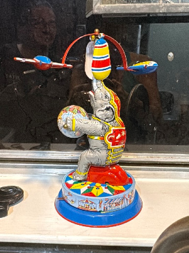 Tin toy mechanical carousel titled 'Elephant with Two Airplanes' by Wilesco