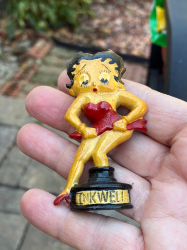 Vintage Betty Boop figurine sitting on an inkwell base