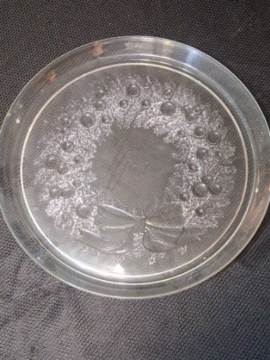 Clear pressed glass 13-inch serving platter with wreath and berries pattern by Indiana Glass Company