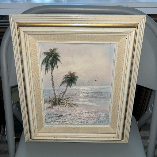 Oil painting on board depicting a tropical beach scene with palm trees