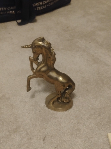 Brass unicorn figurine on circular base
