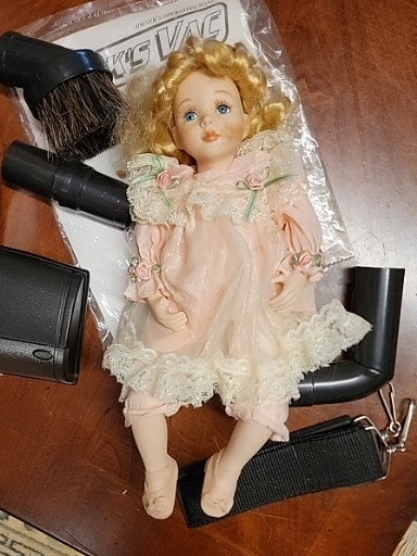 Porcelain collector doll in pink dress with blonde curly hair