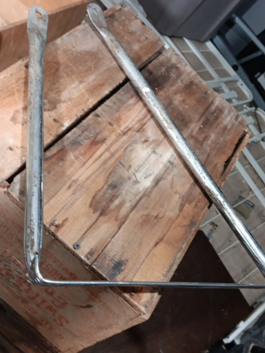 Vintage metal U-bolt or frame bracket, likely from automotive or agricultural equipment