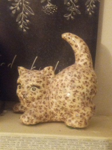 Ceramic cat figurine with floral decoupage decoration