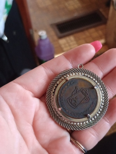 Silver mesh coin purse with decorative medallion clasp