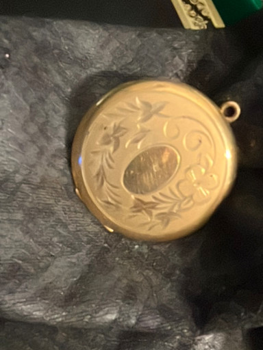 Gold-filled round locket with hand-engraved floral decoration and central monogram cartouche