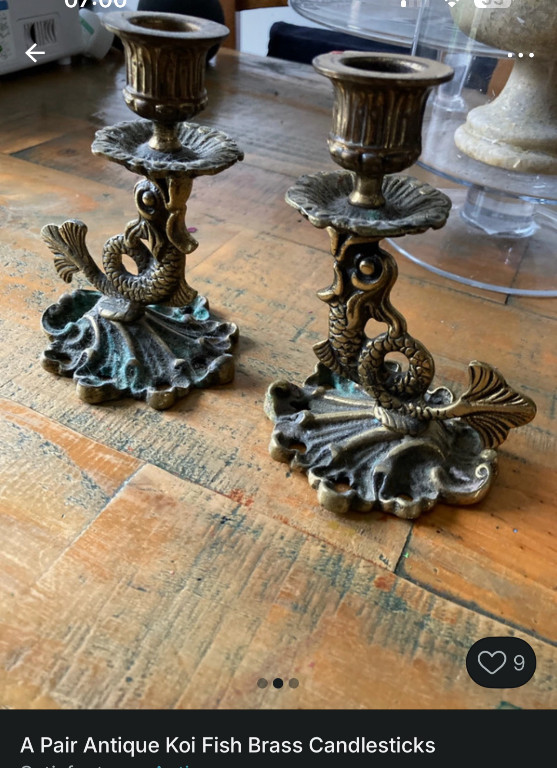 Pair of brass candlesticks with koi fish motifs