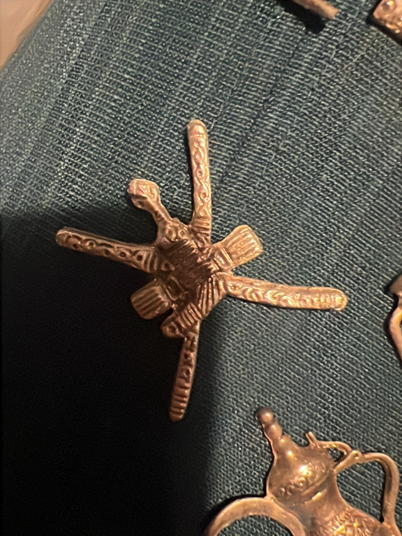 Bronze military collar badge depicting crossed swords and khanjar (traditional Omani dagger) from the Sultan of Oman's Armed Forces