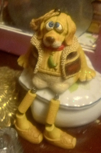 Resin figurine titled 'Dog Shelf Sitter with Jointed Legs' by Dennis East International