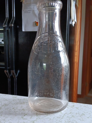 Glass milk bottle embossed 'Uncle Sam's Farm' by E.J. Perry, one quart size