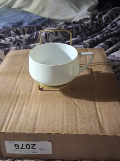 Porcelain teacup with gold handle