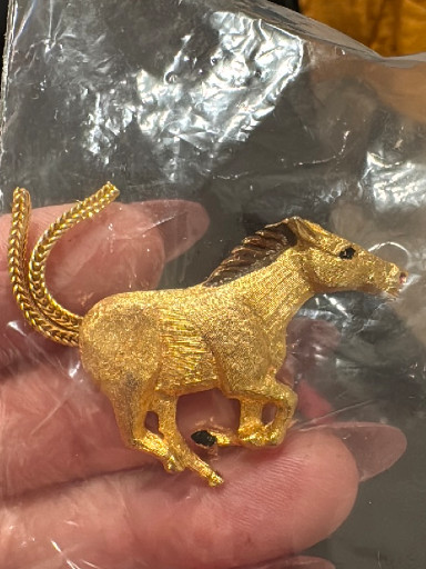 Gold-tone metal horse pendant on chain
