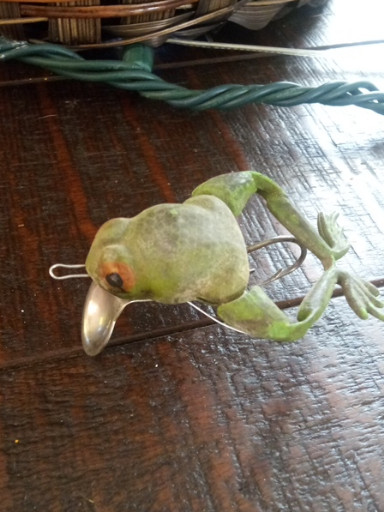 Vintage weedless frog fishing lure with rubber legs and metal spoon