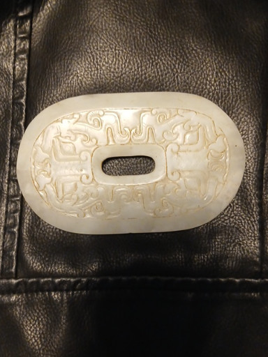 White jade plaque or belt buckle with carved dragon and cloud motifs