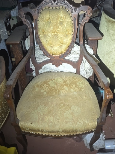Victorian walnut armchair with carved figural crest and gold damask upholstery