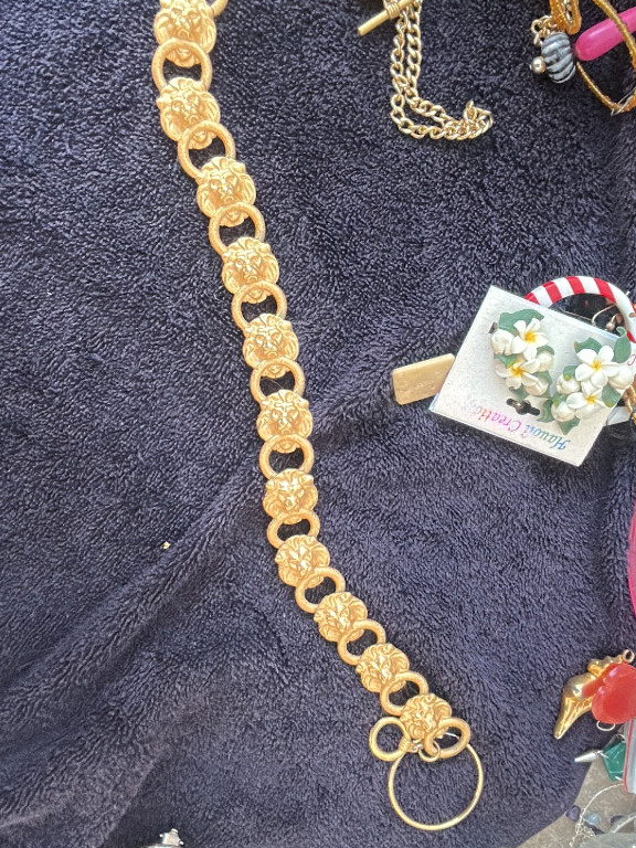 Gold-tone statement necklace 'D'Orlan #2322' featuring five lion head links with rhinestone green eyes