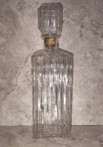 Vintage pressed glass liquor decanter with ribbed vertical pattern and square stopper