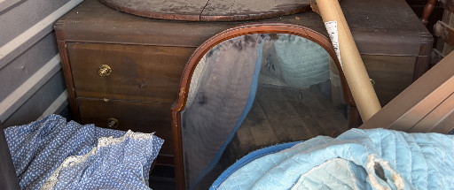 Vintage wooden dresser with oval mirror, circa 1920s–1930s