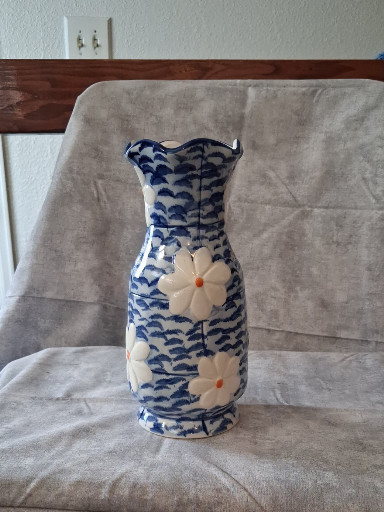 Ceramic vase with blue brushstroke pattern and white floral decoration