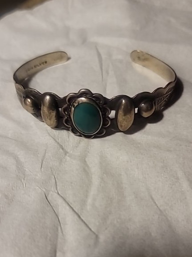 Sterling silver cuff bracelet with turquoise stone by Native American artisan