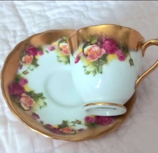 Porcelain tea cup and saucer set titled 'Golden Rose' by Royal Chelsea