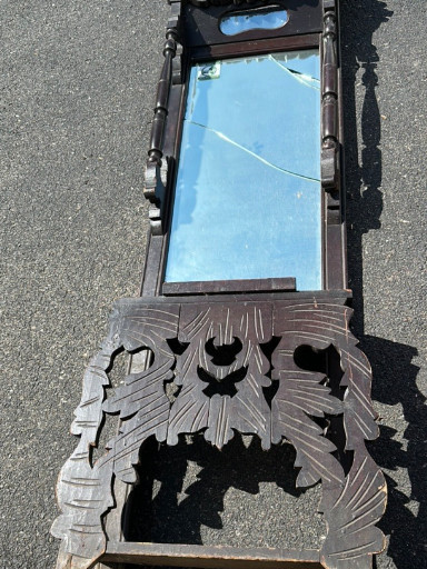 Carved wooden mirror frame with ornate foliate and scrollwork decoration, likely Chinese or Black Forest origin