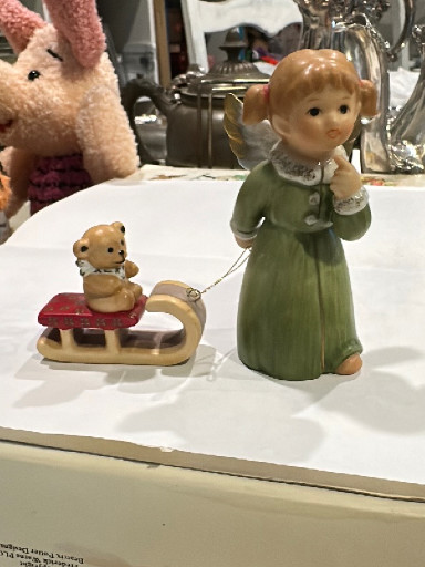 Porcelain figurine titled 'Angel with Teddy Bear on Sled' by Goebel