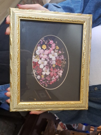 Framed pressed flower arrangement in decorative gold frame