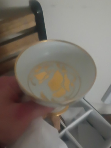 Porcelain teacup with gold floral decoration