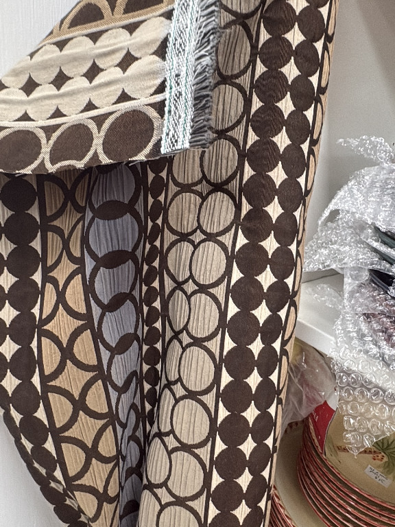 Upholstered furniture piece featuring geometric patterned fabric with brown and cream motifs