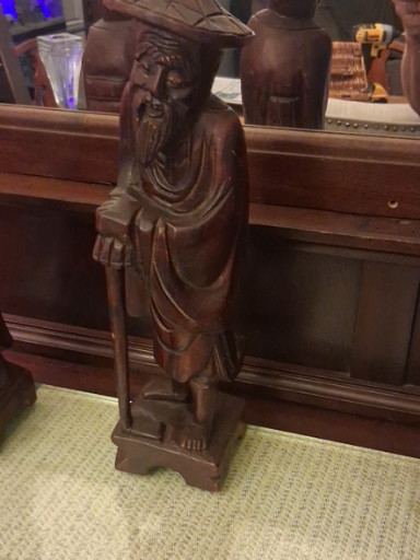Hand-carved wooden figurine depicting a Chinese sage or immortal