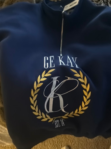 Modern branded quarter-zip sweatshirt labeled 'CE KAY EST. A'