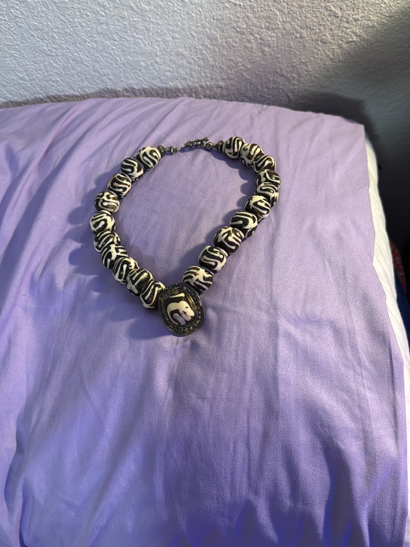 Bone bead necklace with black and white batik pattern and medallion pendant