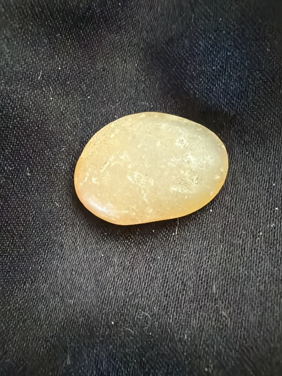 Polished natural golden amber palm stone