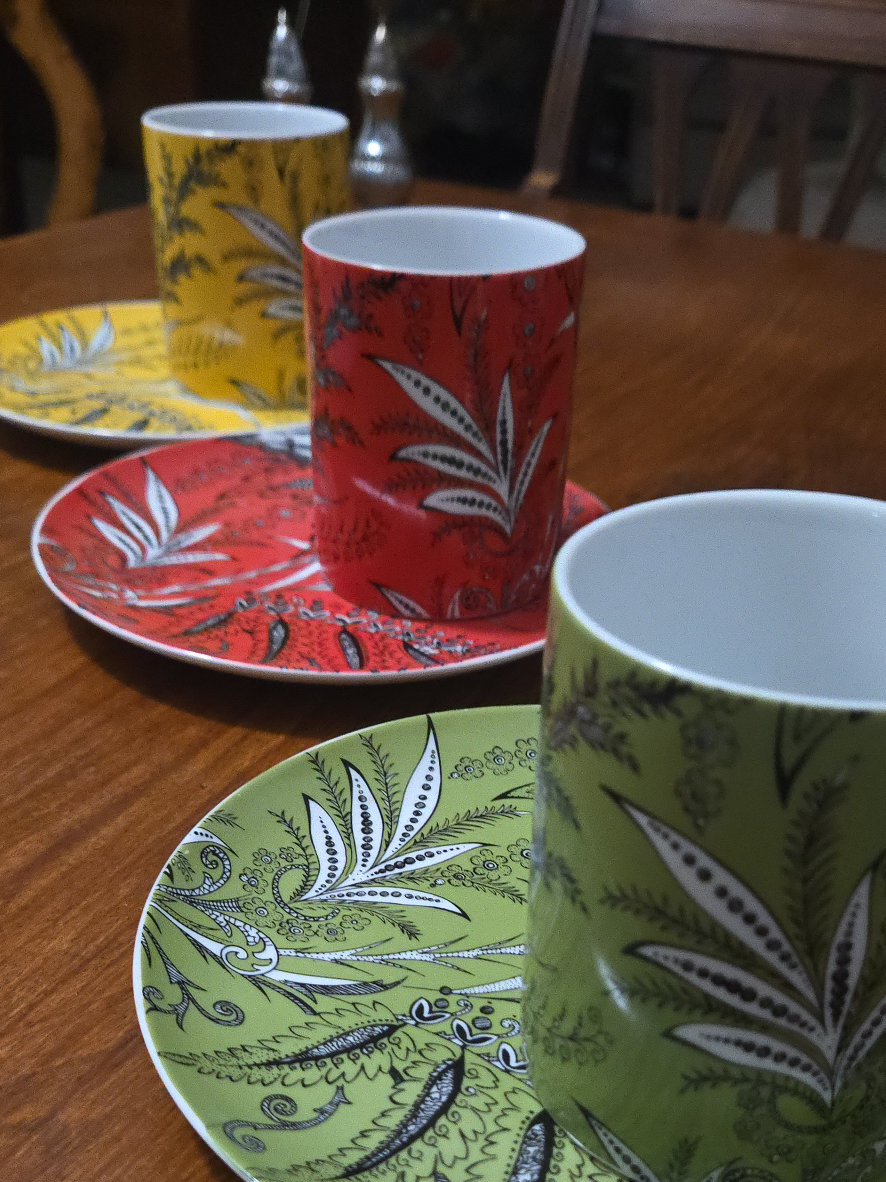 Porcelain coffee cup and saucer set with botanical design in three colors