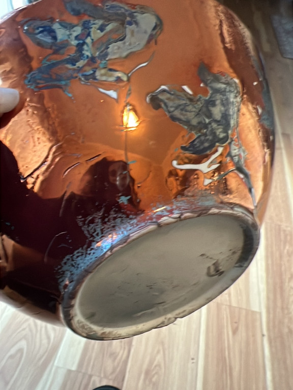 Handcrafted ceramic vessel with Raku-style glazing featuring iridescent metallic and multi-colored surface