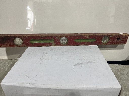 Vintage wooden spirit level with brass and glass vials