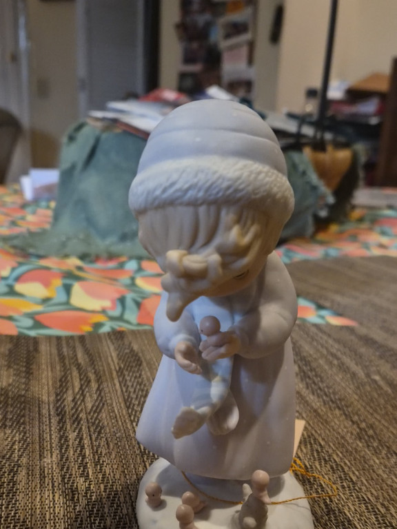 Porcelain figurine titled 'Winter Song' from the Four Seasons Series by Precious Moments