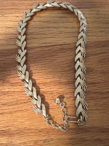 Silvertone metal choker necklace with stylized leaf or feather link design by Trifari