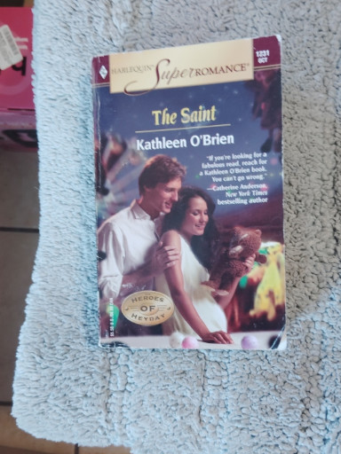 Paperback romance novel titled 'The Saint' by Kathleen O'Brien