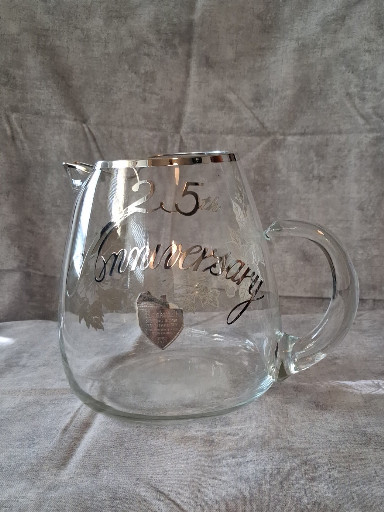 Clear glass pitcher with silver overlay commemorating '25th Anniversary'