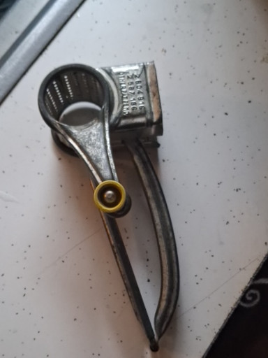 Vintage metal hand-crank cheese grater titled 'Mouli Grater' made in France