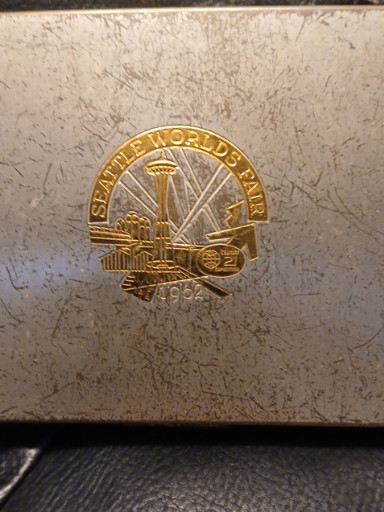 Bronze medal from 1962 Seattle World's Fair (Century 21 Exposition), mounted on a leather wallet or cigarette case